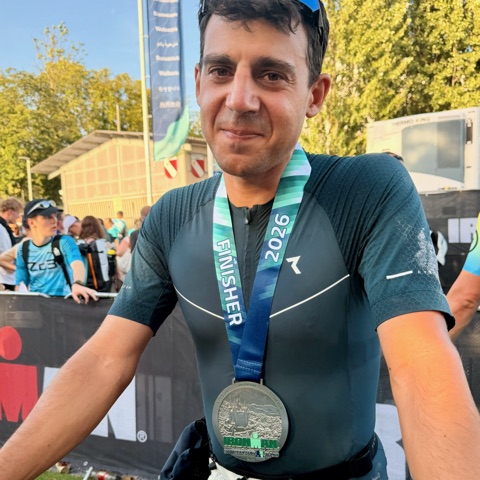 Lukas at the Ironman finish line, medal around his neck